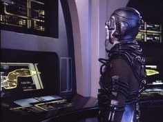 Part man, part machine, an anonymous Borg drone inspects the engineering readouts of the Enterprise, prior to an attempted assimilation of the Enterprise's computer banks.