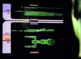 We look over Commander Data's shoulder at a LCARS viewscreen on the bridge of the USS Enterprise, from the ST:TNG episode "The Naked Now".  Though the green text is much too small to read, the ship class being displayed is most certainly the Orion Wanderer from the FASA Starship Combat game rules manual.